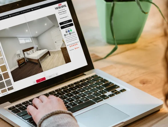 Woman using the state of the art Roomvo room visualizer to complete a flooring project.